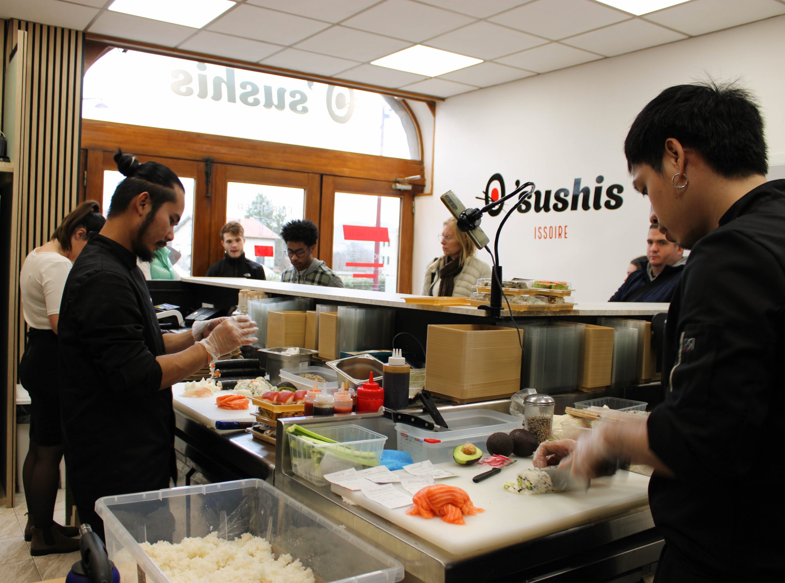 Cuisiniers en pleine préparation de sushis dans le restaurant O’Sushis à Issoire, photographie réalisée dans le cadre des services de communication à Clermont-Ferrand, exemple de réalisation en communication 360° à Clermont par Clap Agency.